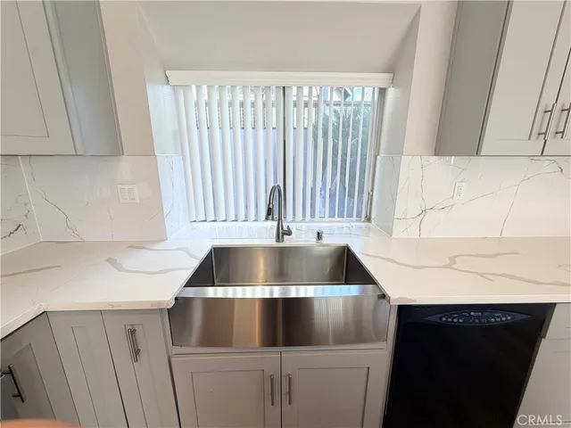 a kitchen with a sink and cabinets