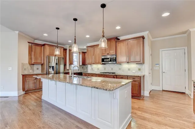 a large kitchen with granite countertop a stove oven and a sink with granite countertops