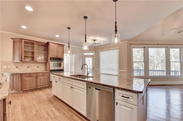 a kitchen with granite countertop a sink and a stove