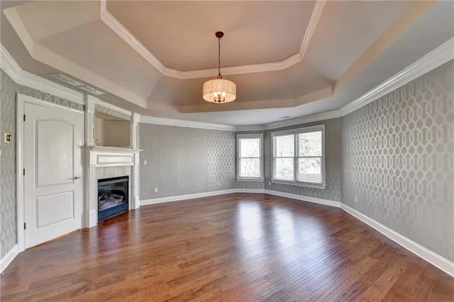 a spacious bathroom with a granite countertop double vanity sink a mirror and a shower