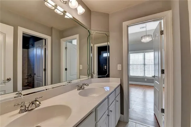 a bathroom with a sink a toilet and mirror