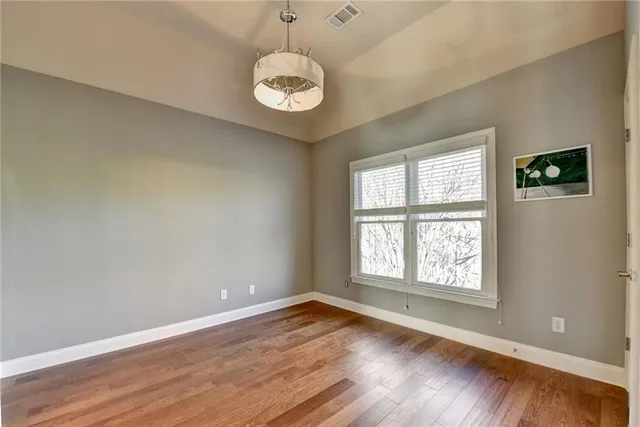 a balcony with wooden floor and bench