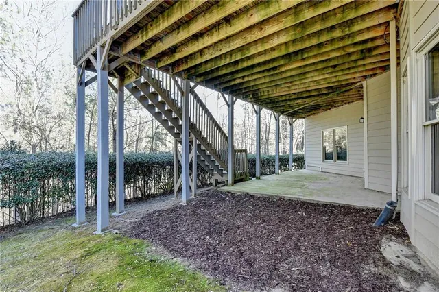 an aerial view of a house with a yard and trees