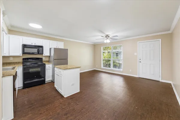 a kitchen with a stove a refrigerator and a sink
