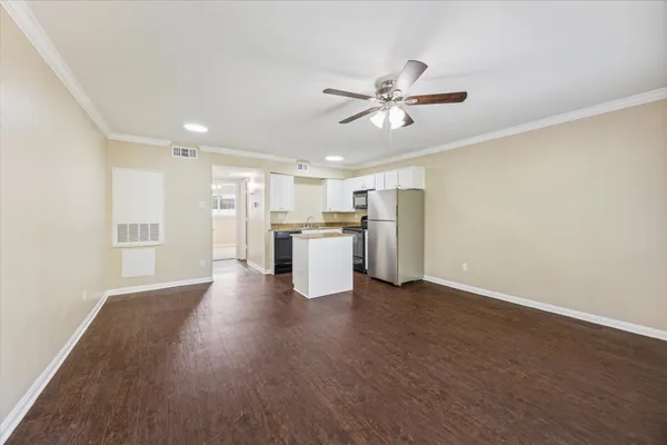 a view of a kitchen with a sink refrigerator and wooden floor