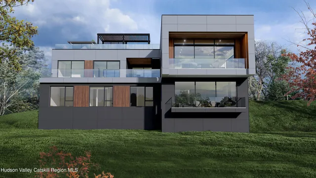 an aerial view of a houses with a yard and lake view