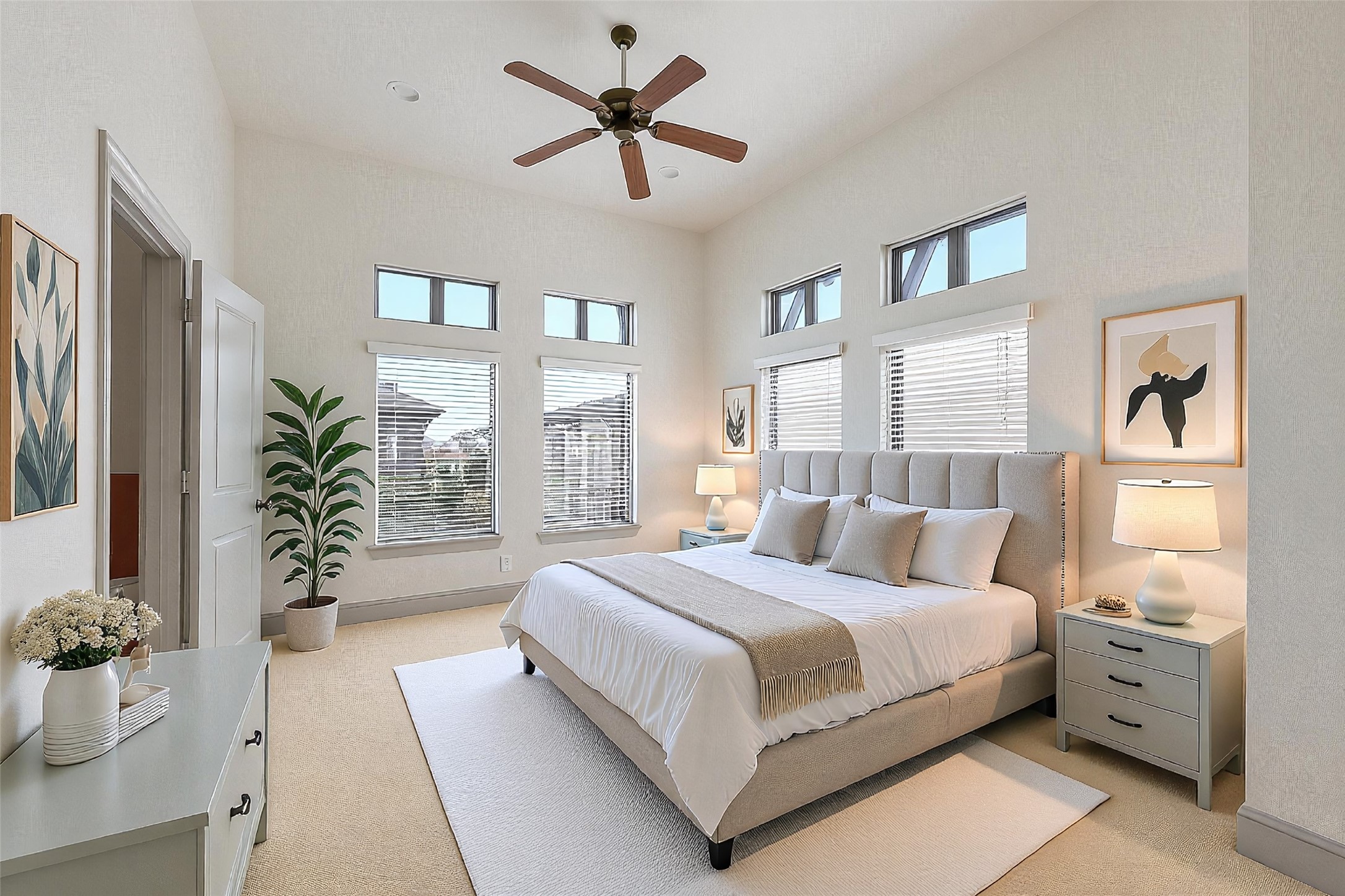 1929 Summer Street Houston, TX 77007 - Photo 14 of 27 Expansive third-floor primary suite with 11’ ceiling height, new carpet (2025), recessed can lighting, ceiling fan, and abundant natural light. Door to the left leads into the en suite primary bathroom. The furniture in this photo is virtually staged.