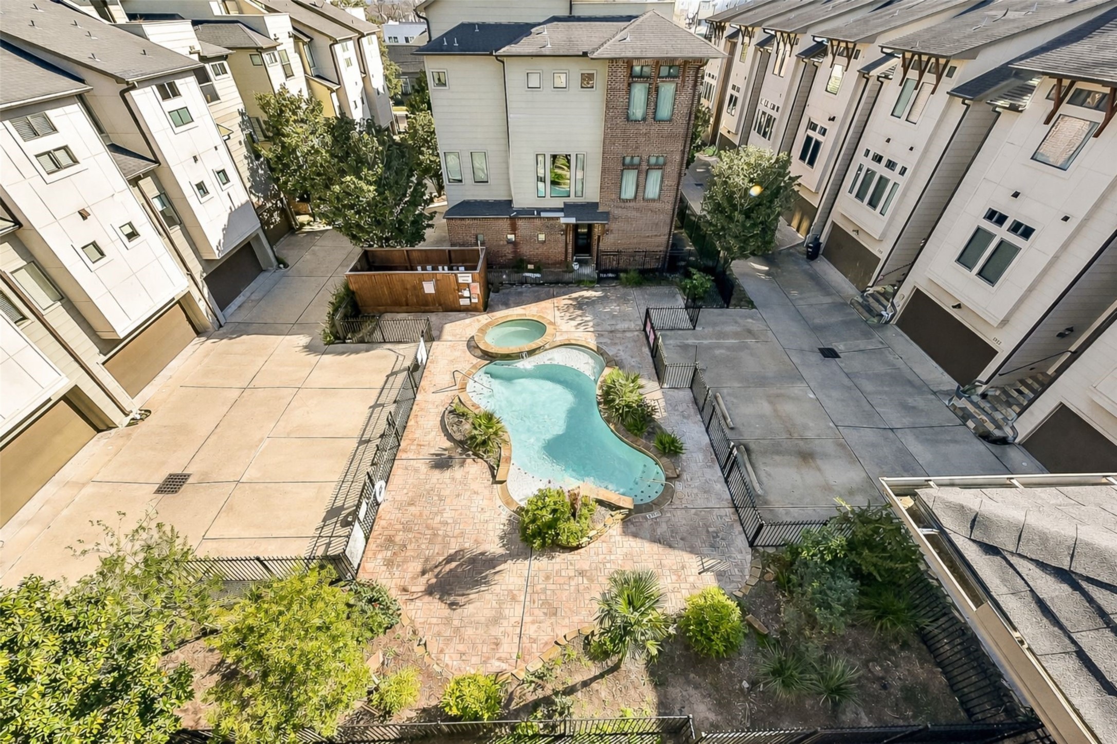 1929 Summer Street Houston, TX 77007 - Photo 25 of 27 Aerial view from the rooftop terrace highlighting the rare corner-lot positioning—one of only two homes in the community that sides to the pool area.