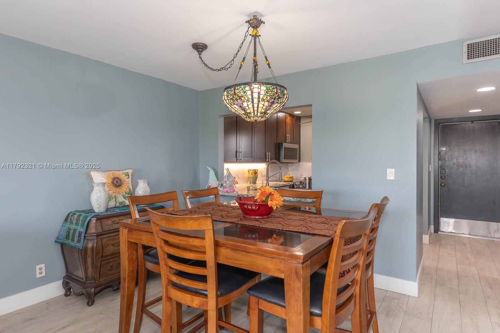 950 Hillcrest Drive, Unit 414 Hollywood, FL 33021 - Photo 11 of 51 a view of a dining room with furniture and wooden floor