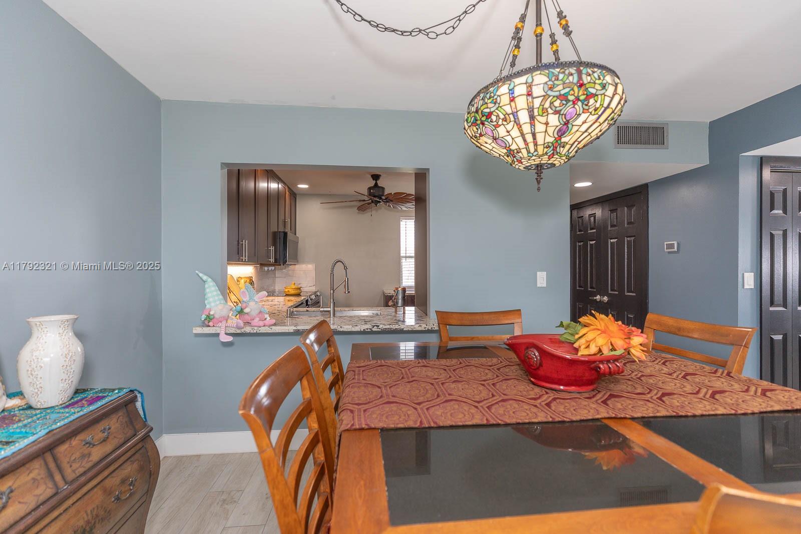 950 Hillcrest Drive, Unit 414 Hollywood, FL 33021 - Photo 12 of 51 a bedroom with furniture and a chandelier