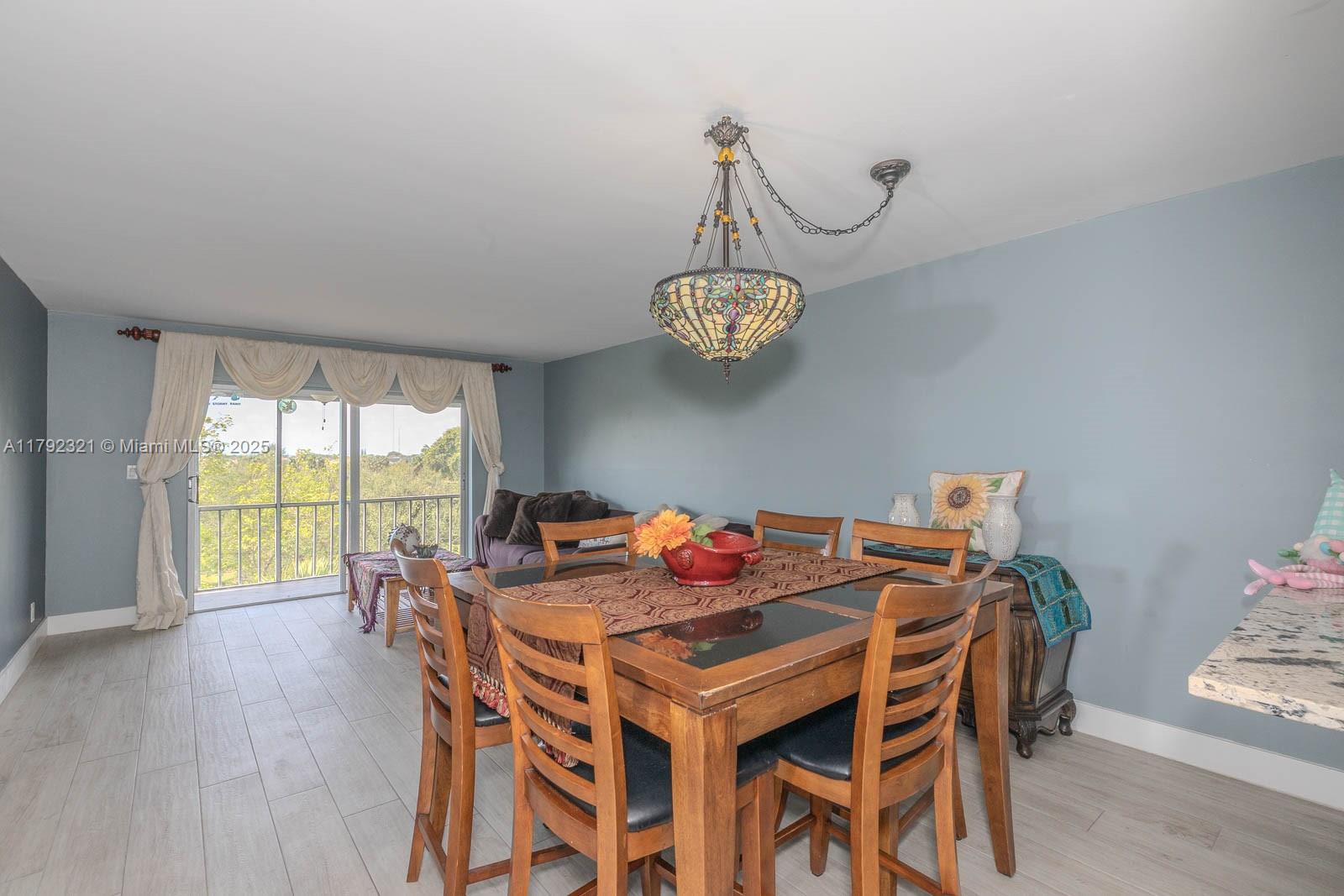 950 Hillcrest Drive, Unit 414 Hollywood, FL 33021 - Photo 13 of 51 a view of a dining room with furniture window and wooden floor
