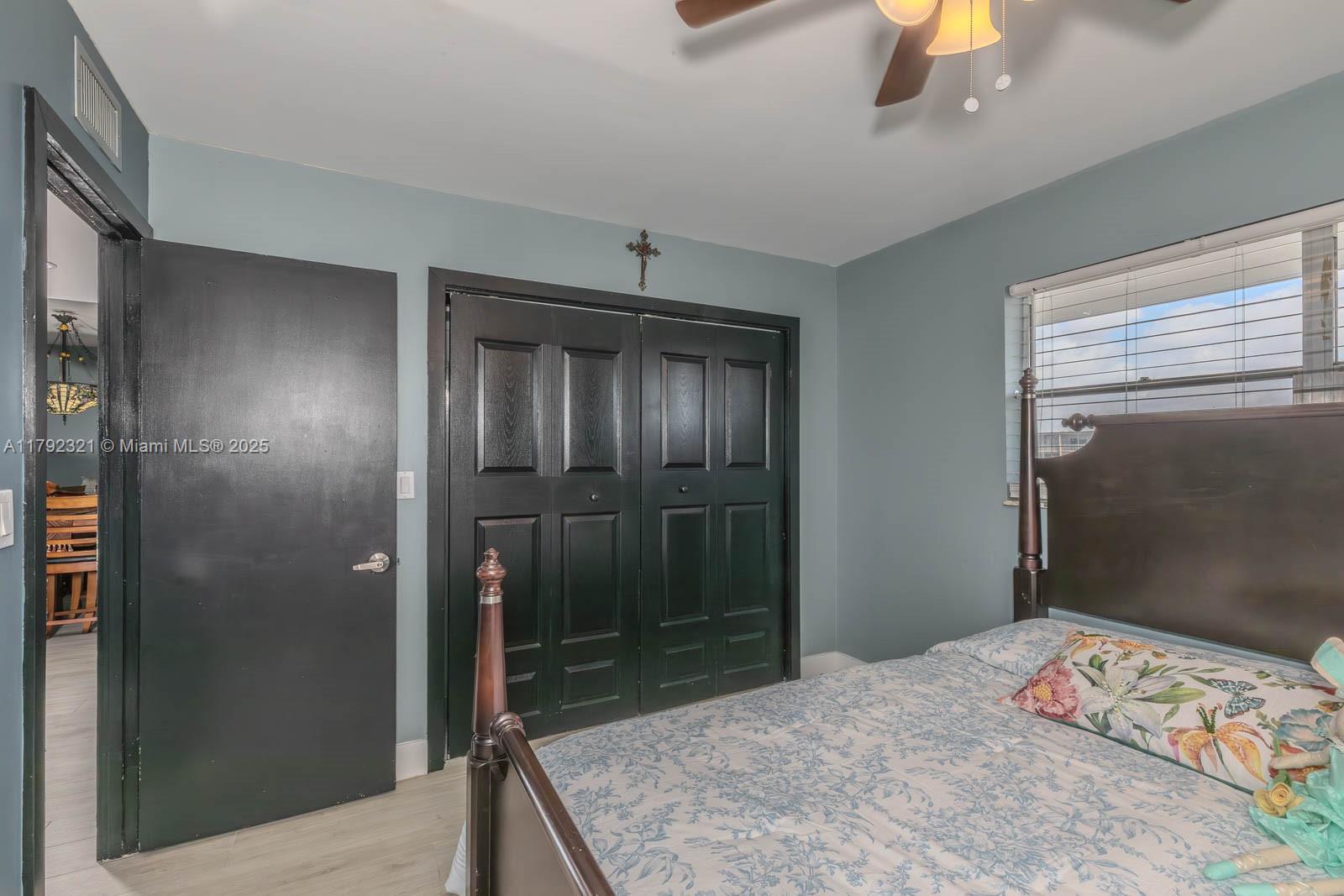 950 Hillcrest Drive, Unit 414 Hollywood, FL 33021 - Photo 22 of 51 a bedroom with a bed and a dresser in it