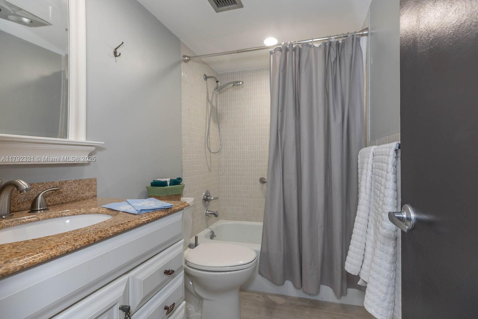 950 Hillcrest Drive, Unit 414 Hollywood, FL 33021 - Photo 25 of 51 a bathroom with a granite countertop sink toilet and shower