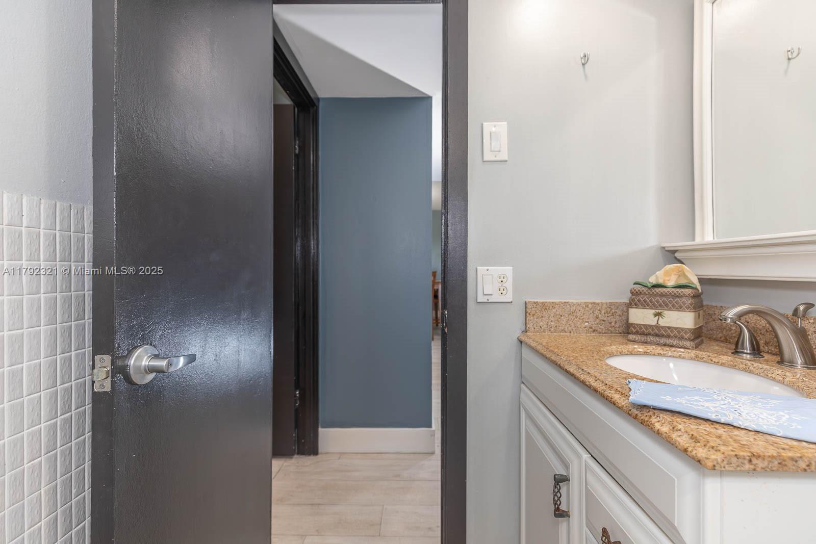 950 Hillcrest Drive, Unit 414 Hollywood, FL 33021 - Photo 26 of 51 a bathroom with a sink and a mirror