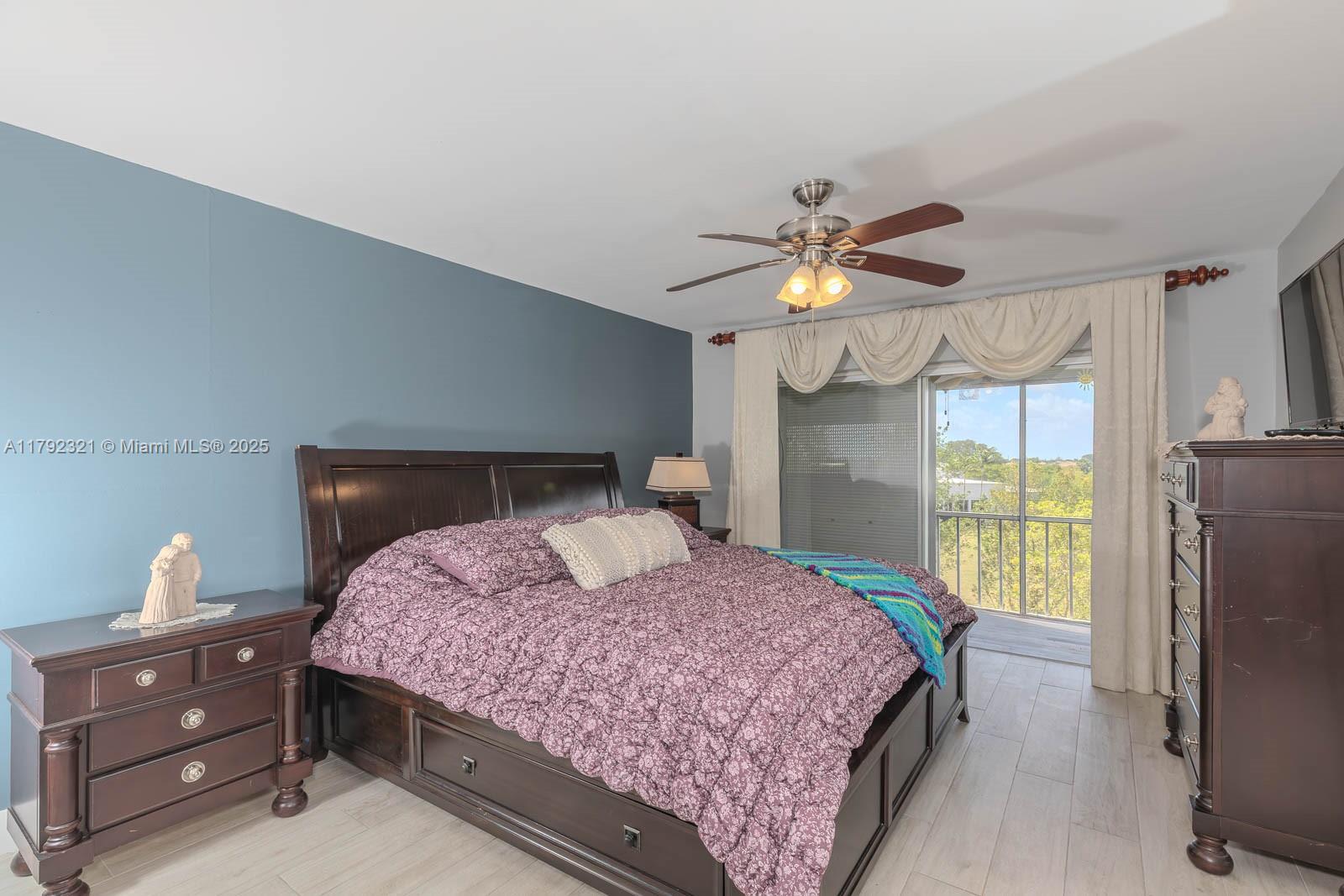 950 Hillcrest Drive, Unit 414 Hollywood, FL 33021 - Photo 28 of 51 a bedroom with a bed and a chandelier