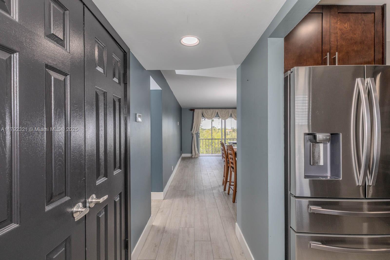 950 Hillcrest Drive, Unit 414 Hollywood, FL 33021 - Photo 3 of 51 a view of a hallway with wooden cabinets