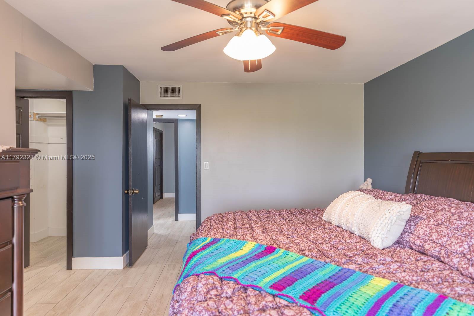 950 Hillcrest Drive, Unit 414 Hollywood, FL 33021 - Photo 31 of 51 a bedroom with a bed and a chandelier