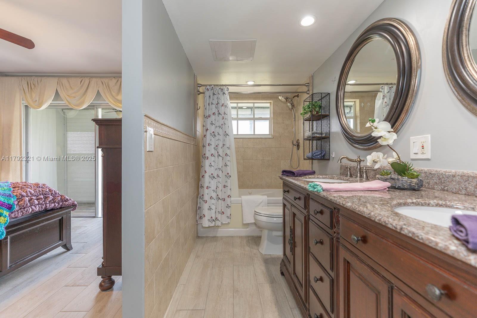 950 Hillcrest Drive, Unit 414 Hollywood, FL 33021 - Photo 35 of 51 a spacious bathroom with a granite countertop double vanity sink and a mirror