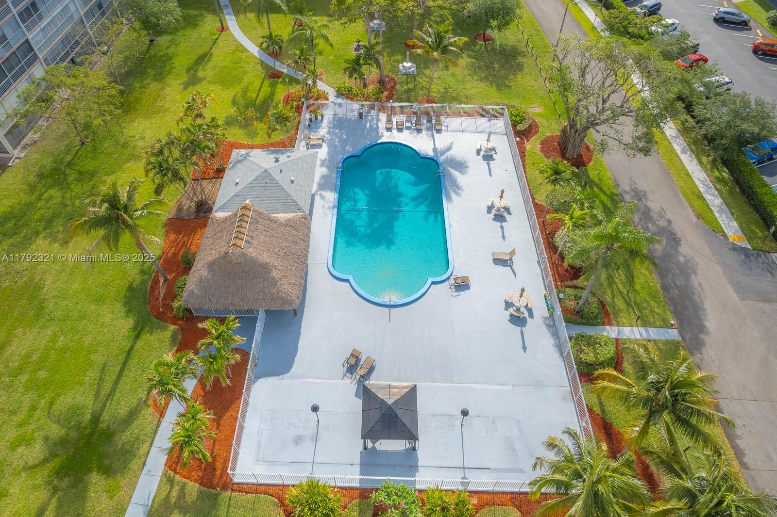 950 Hillcrest Drive, Unit 414 Hollywood, FL 33021 - Photo 46 of 51 an aerial view of a house with swimming pool and large trees
