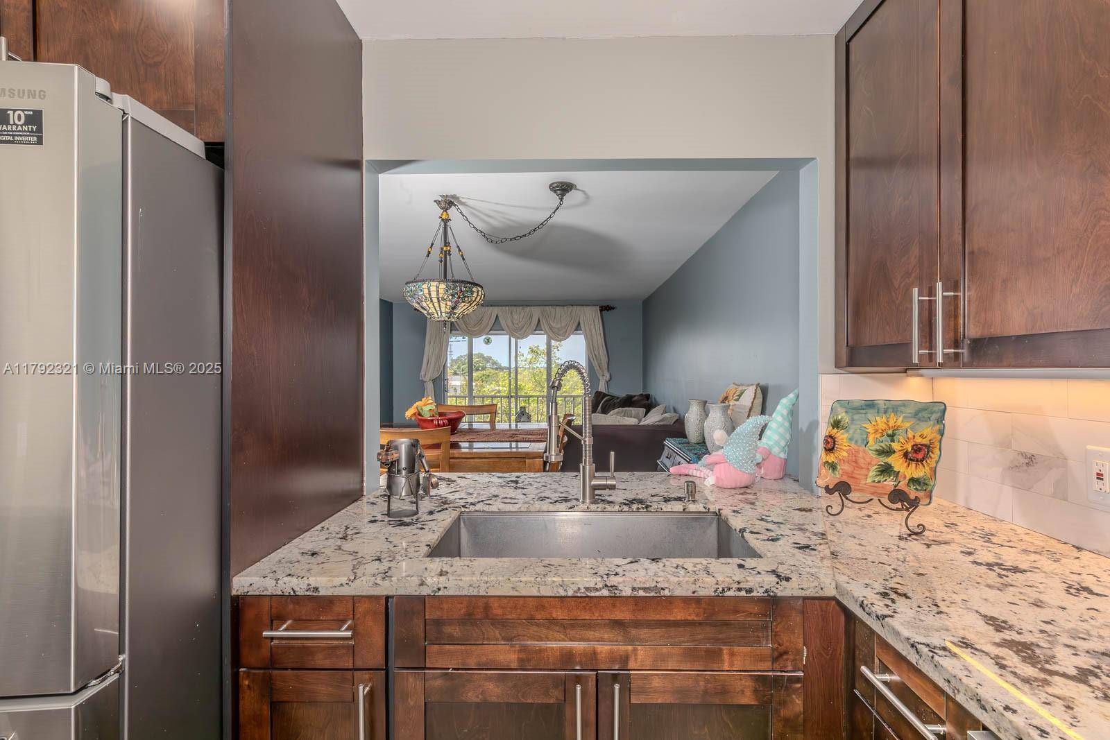 950 Hillcrest Drive, Unit 414 Hollywood, FL 33021 - Photo 6 of 51 a kitchen with stainless steel appliances granite countertop a sink stove and refrigerator