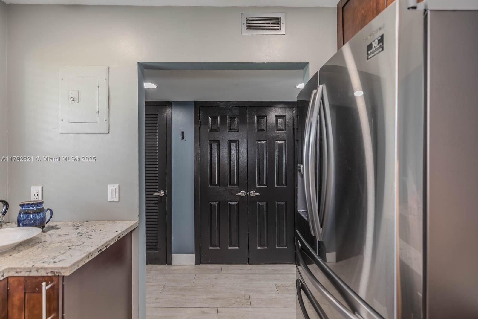 950 Hillcrest Drive, Unit 414 Hollywood, FL 33021 - Photo 9 of 51 a view of a kitchen from the hallway