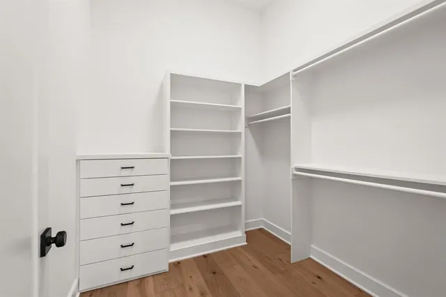 a view of walk in closet with empty racks