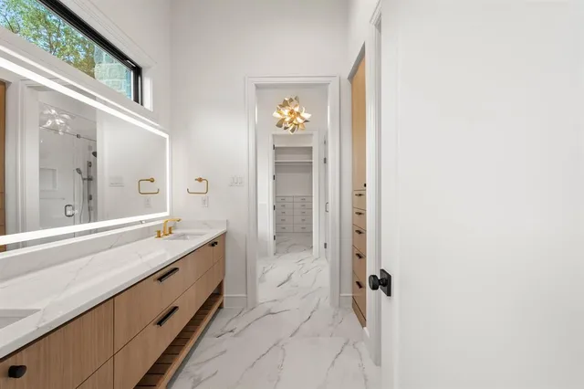 a spacious bathroom with a double vanity sink and a mirror