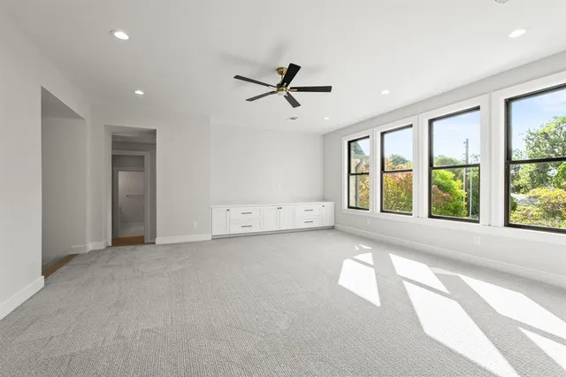 a view of a livingroom with a ceiling fan and window
