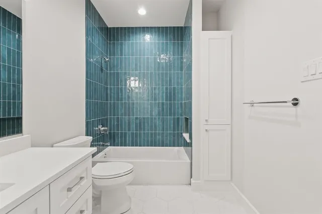 a bathroom with a toilet a sink and bathtub
