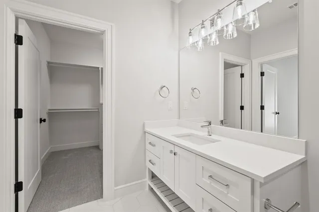 a spacious bathroom with a sink a mirror and a shower
