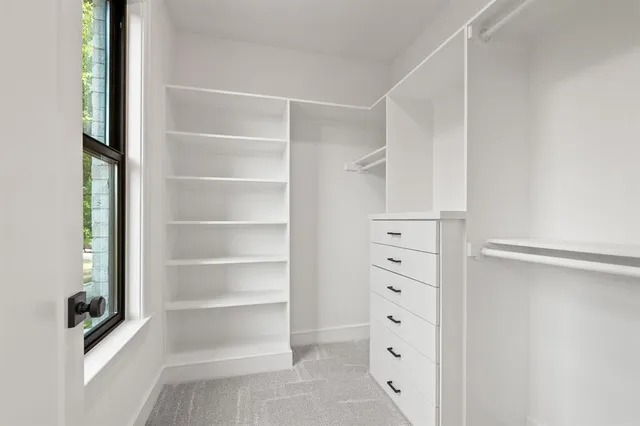 a view of walk in closet with empty racks