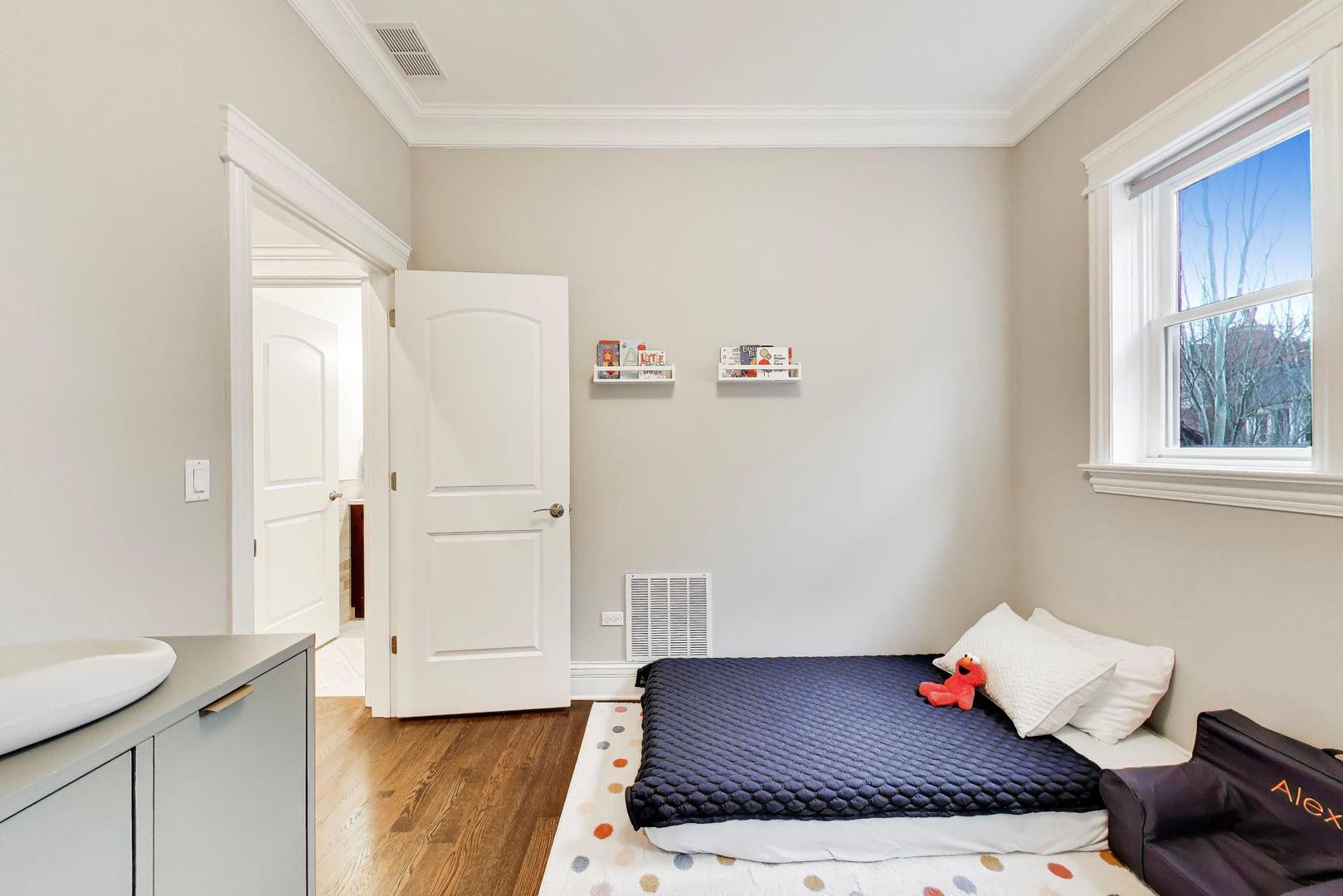 2680 North Orchard Street, Unit 3 Chicago, IL 60614 - Photo 16 of 26 a bedroom with a bed and a window