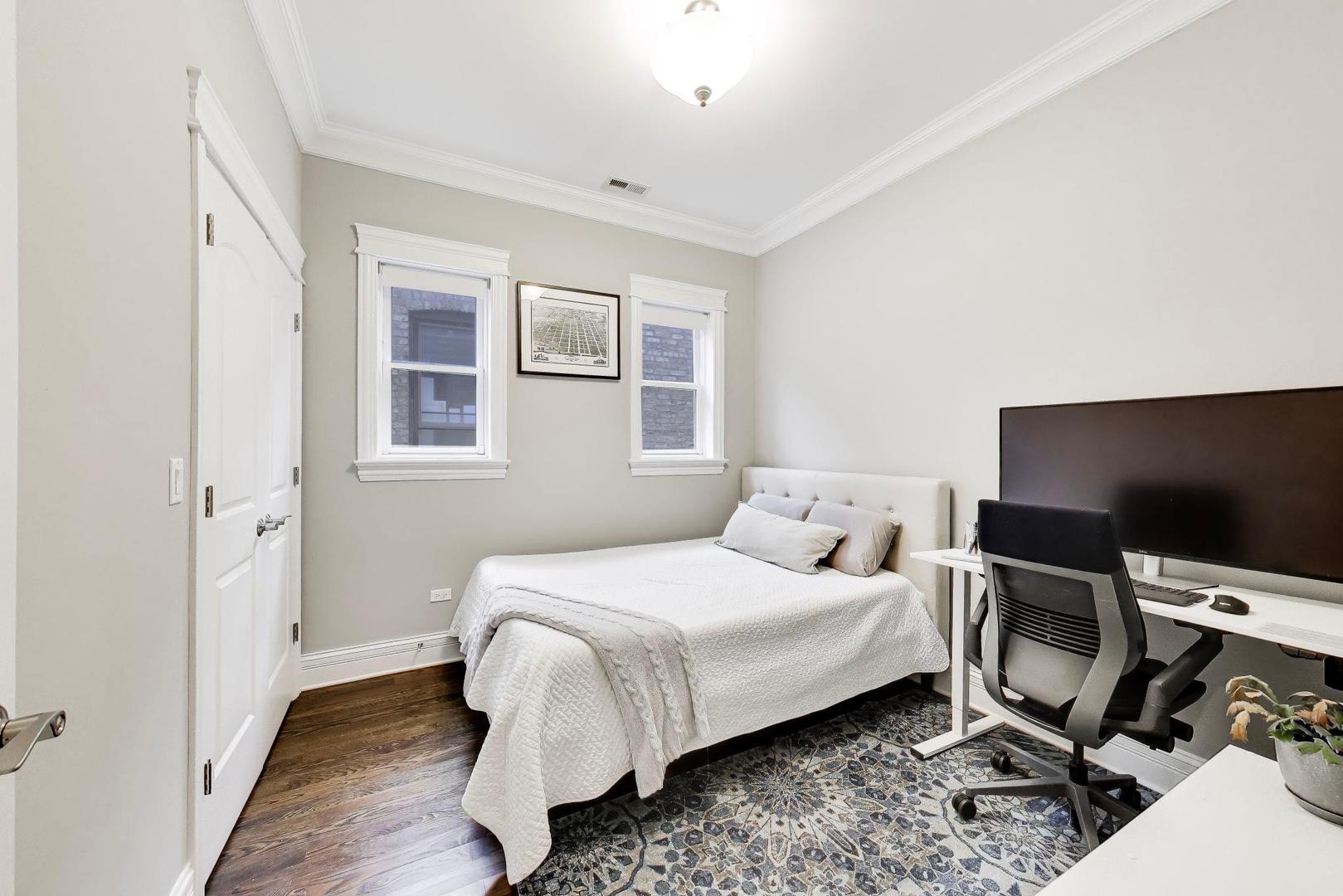 2680 North Orchard Street, Unit 3 Chicago, IL 60614 - Photo 19 of 26 a bedroom with a bed and glass door