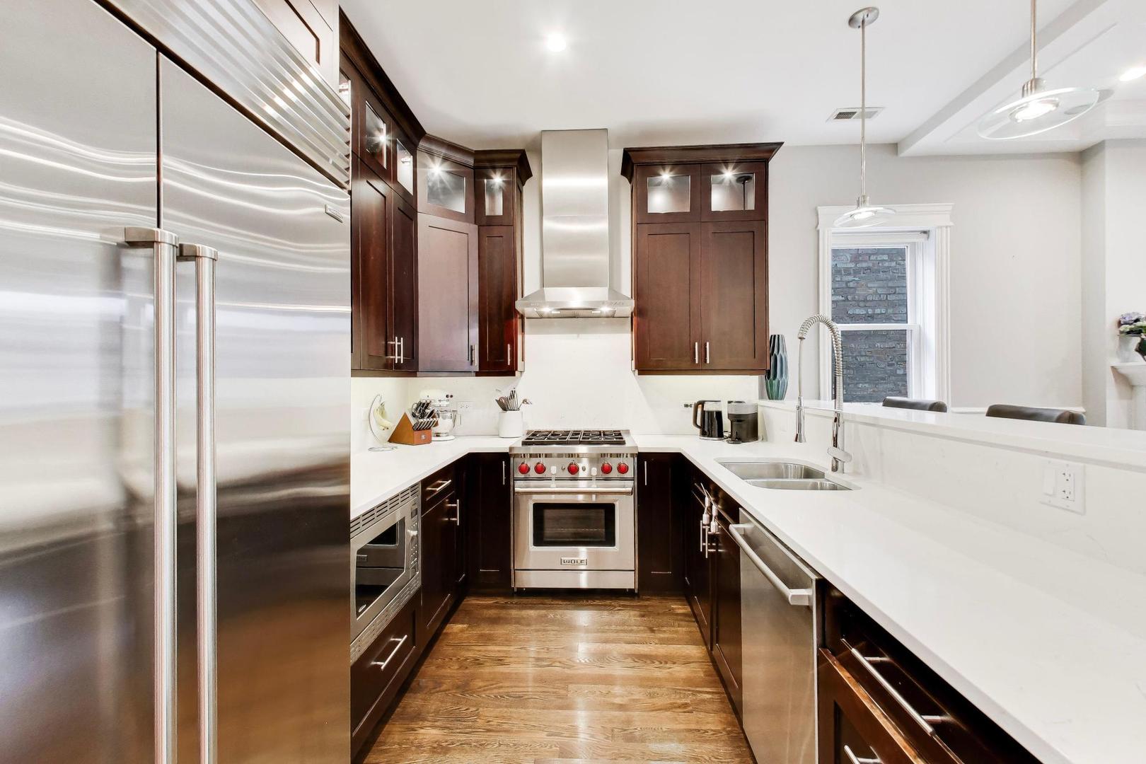 2680 North Orchard Street, Unit 3 Chicago, IL 60614 - Photo 8 of 26 a kitchen with stainless steel appliances granite countertop a sink a stove top oven and refrigerator