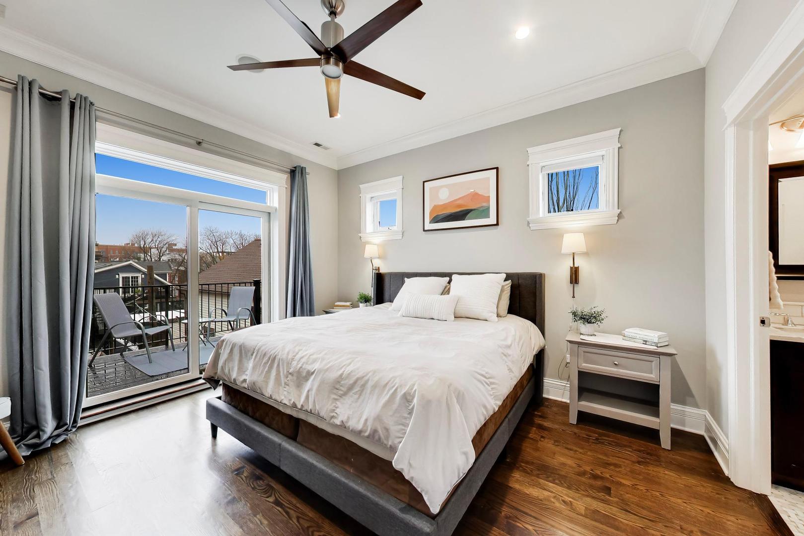 2680 North Orchard Street, Unit 3 Chicago, IL 60614 - Photo 9 of 26 a bedroom with a large bed and a chandelier