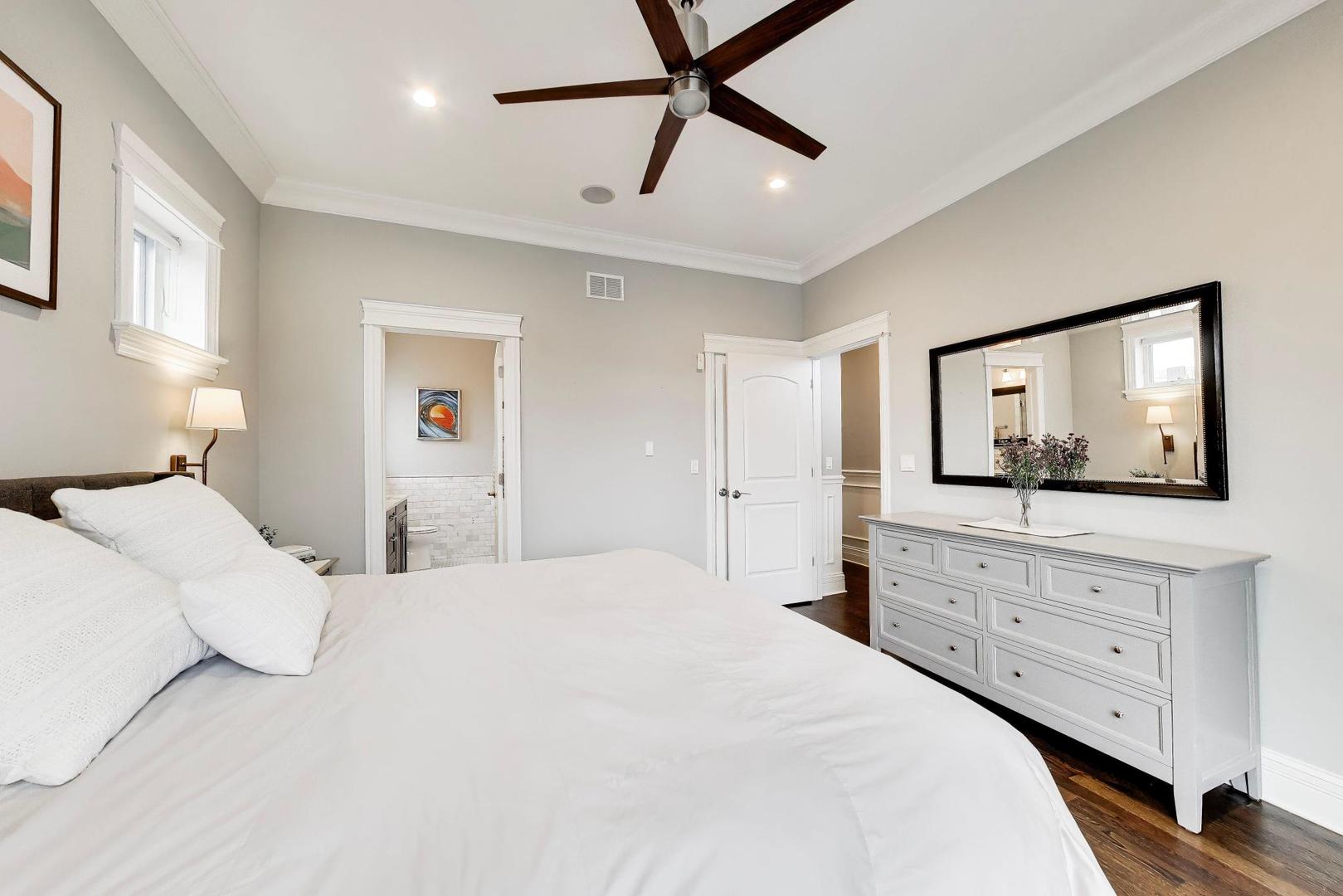 2680 North Orchard Street, Unit 3 Chicago, IL 60614 - Photo 10 of 26 a bedroom with a large bed and a flat tv screen on dresser