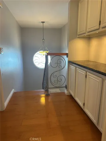 a bathroom with a granite countertop sink and cabinets