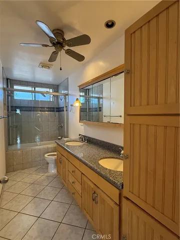 a bathroom with a granite countertop sink a mirror and a bathtub