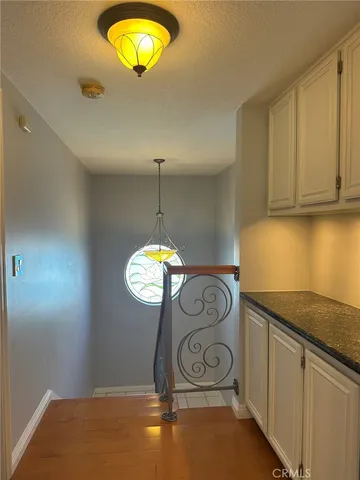 a view of a kitchen cabinets and chandelier