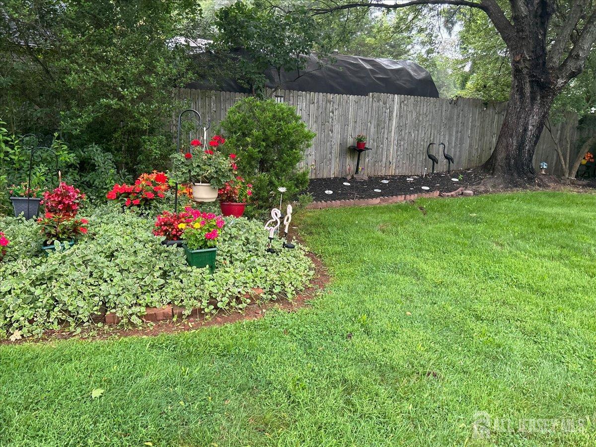33 Ellison Road Somerset, NJ 08873 - Photo 28 of 38 a view of a backyard with potted plants and a large tree