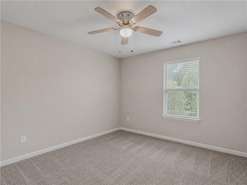 206 Morning Drive Athens, GA 30606 - Photo 24 of 36 an empty room with a window and a fan