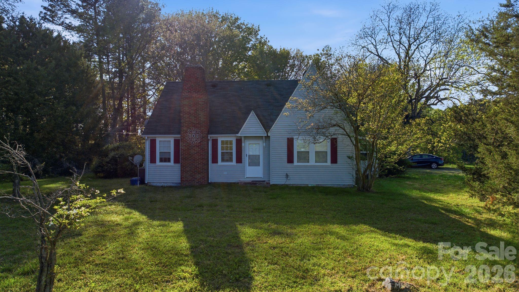 1862 Salem Church Road Lincolnton, NC 28092 - Photo 5 of 12 a house that is sitting in the grass with large trees