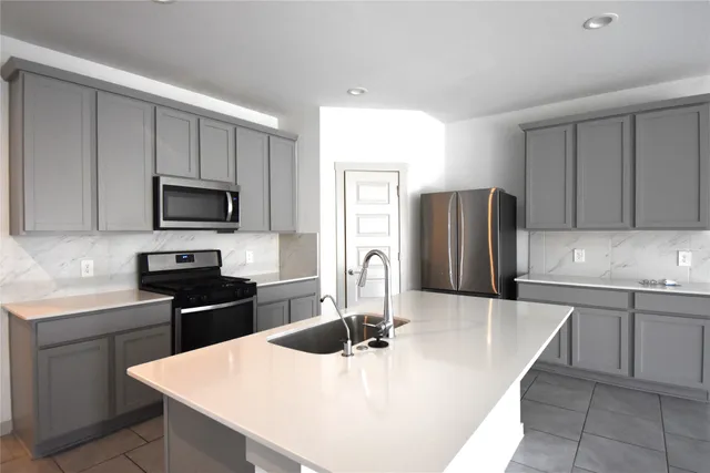 a kitchen with stainless steel appliances wooden floor dining table and chairs