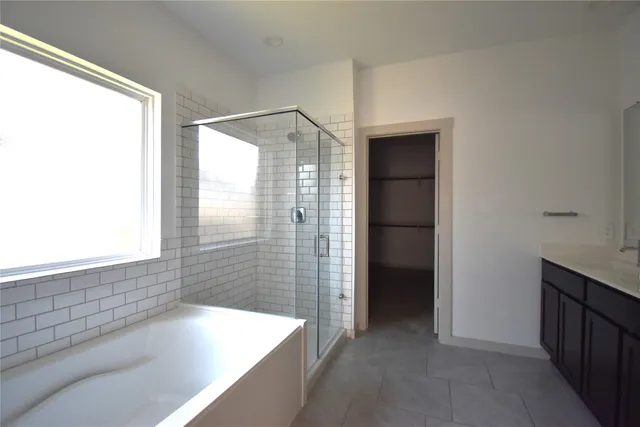 a bathroom with a bathtub and a shower