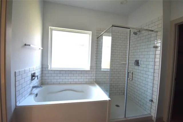 a bathroom with a bathtub and shower