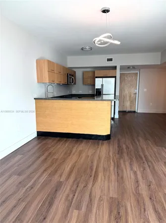 a room with wooden floors and natural light