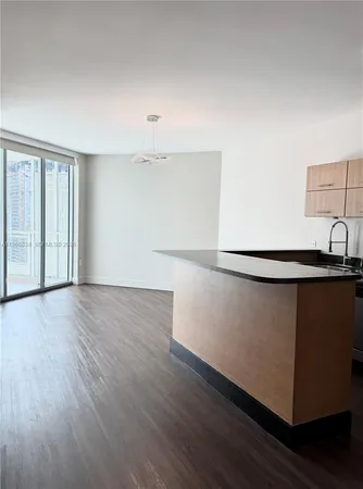 a view of a room with wooden floor and windows