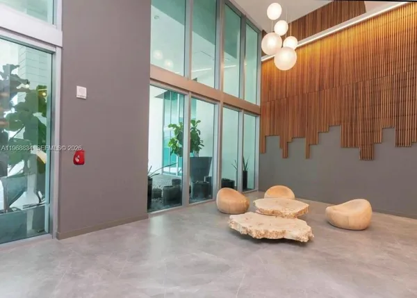 a large white tub sitting in a room next to a lamp