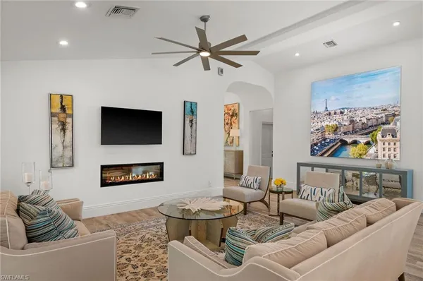 a living room with furniture and a flat screen tv