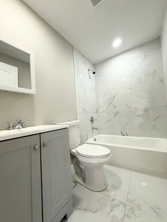 a bathroom with a sink a toilet and bathtub